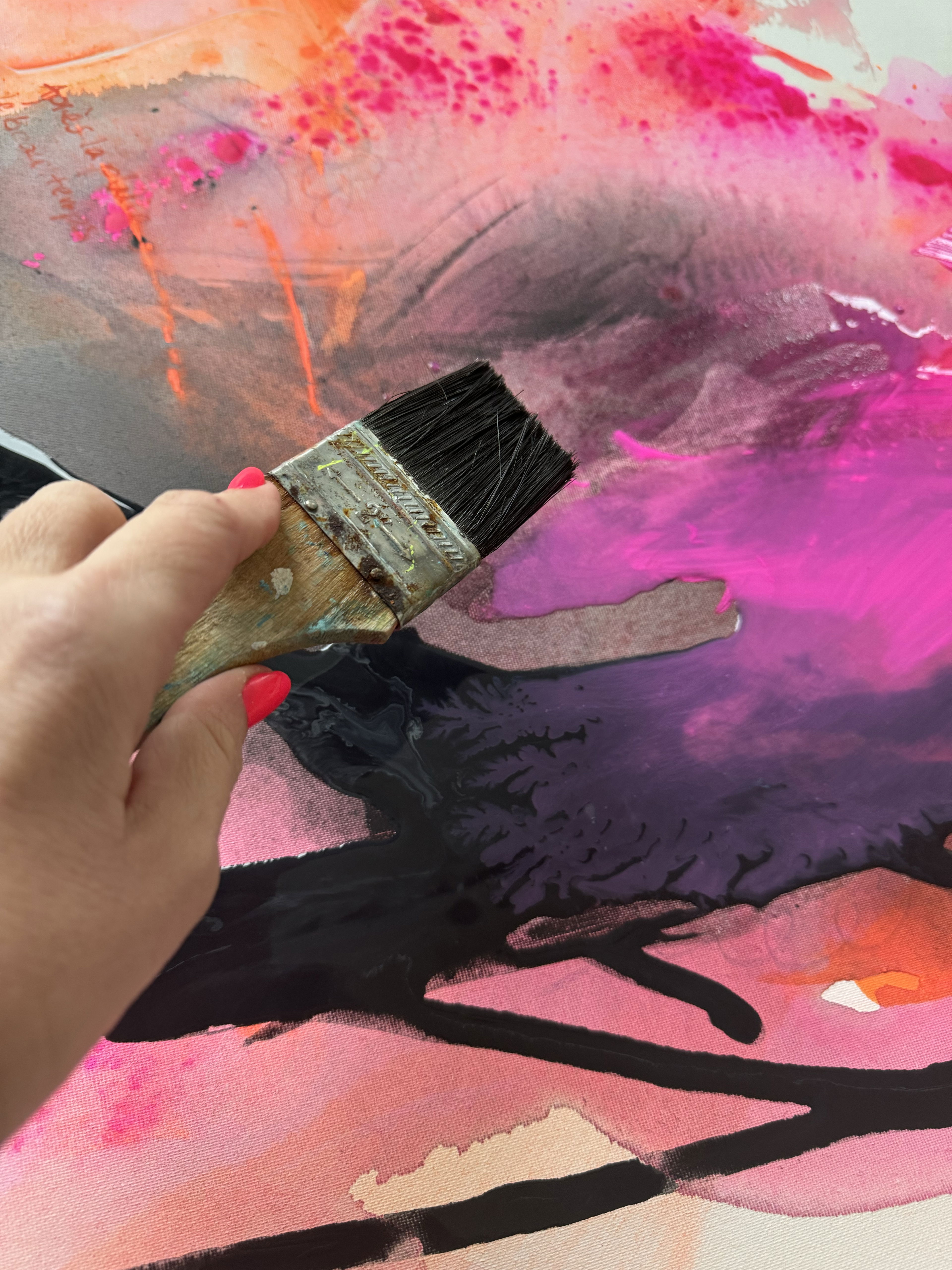 A hand guides a brush through a riot of ethereal pinks, purples, and blacks in an abstract acrylic painting, capturing a luminous dance of chaos and vibrant interplay. Artwork style is Abstrakt and technique Acry auf Leinwand.