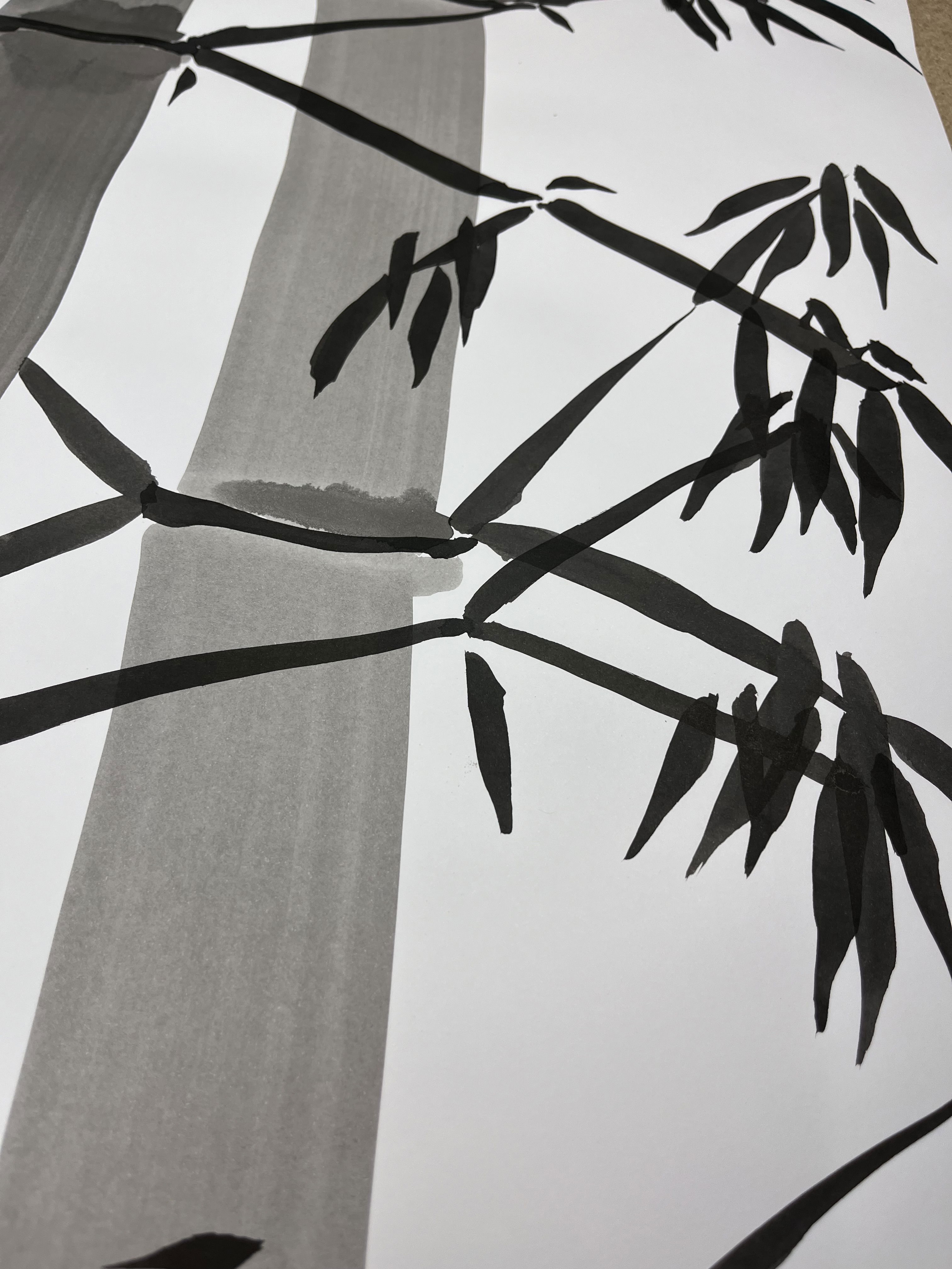 An abstract ink on paper, evoking serene tranquility with monochrome bamboo branches, showcasing minimalist elegance and harmonious brushstrokes in nature's simplicity. Artwork style is Abstrakt and technique Tinte auf Papier.