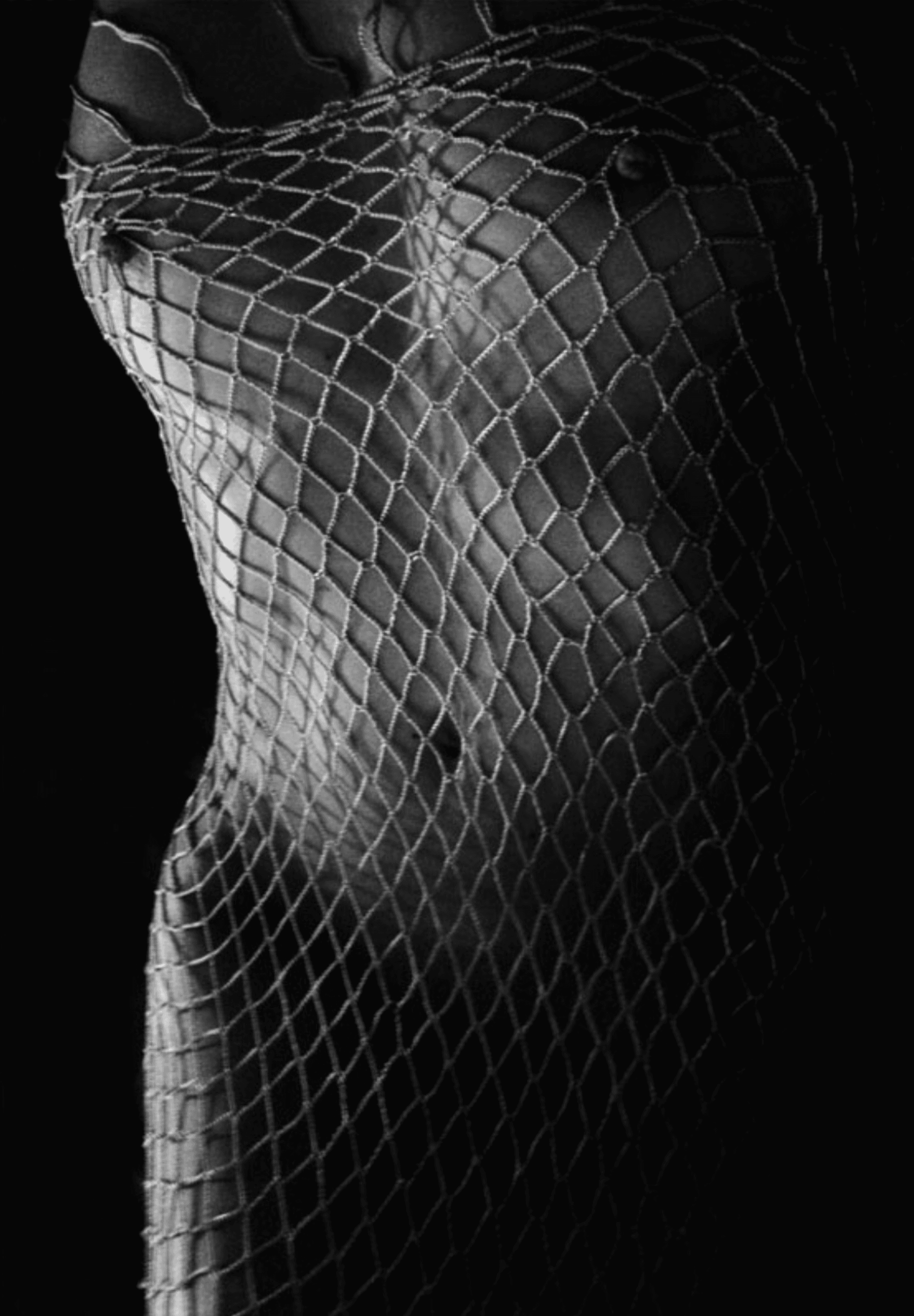 A grayscale photoprint revealing a nude figure ensnared in a net, evoking themes of vulnerability and entanglement through soft shadows and textured contrasts. Artwork style - Figurativ and technique Fotodruck.