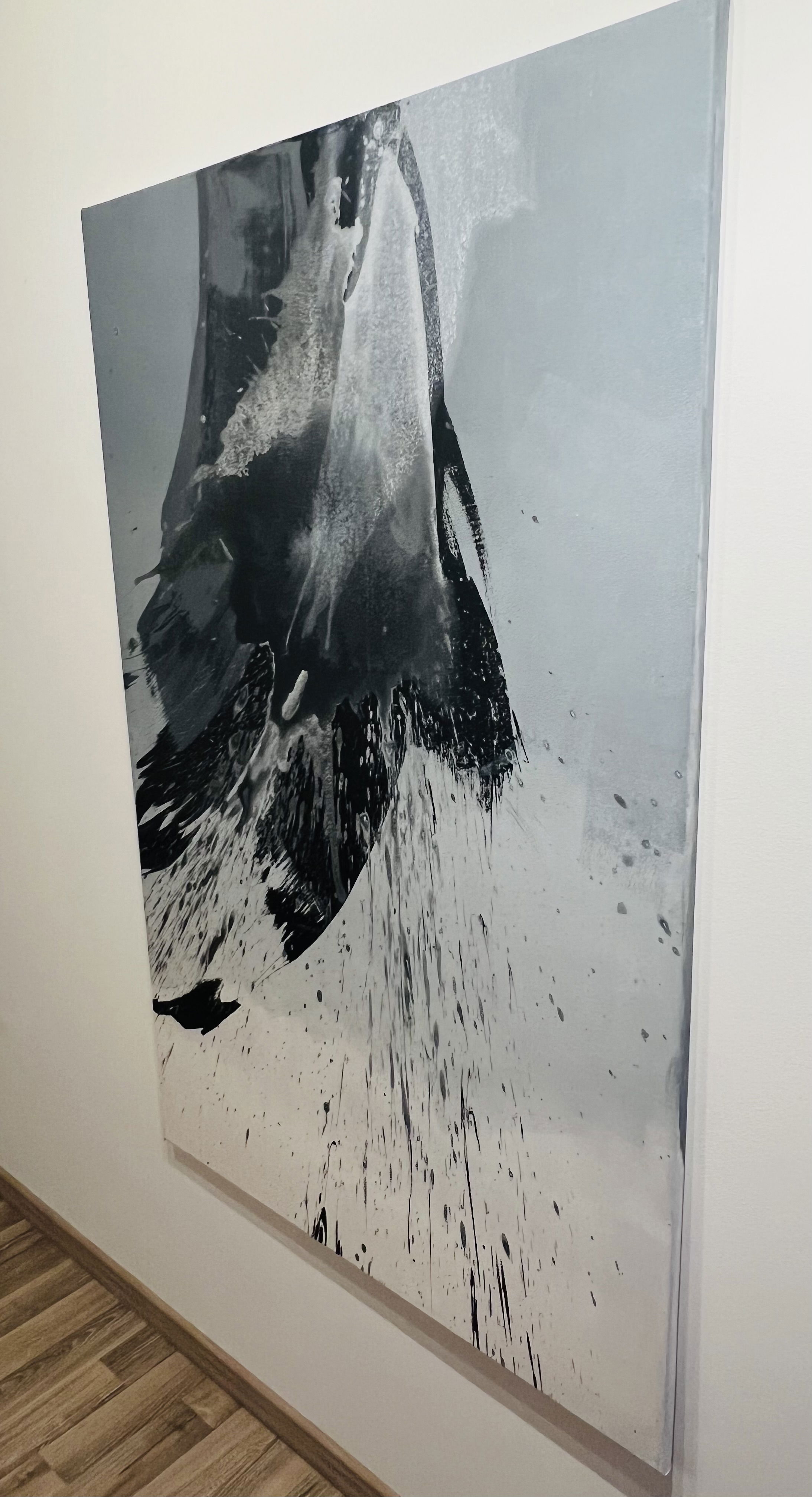 A monochrome abstract acrylic painting captures dynamic fluidity and turbulent motion, with bold contrasts of black splatter and ethereal grayscale textures cascading in enigmatic forms. Artwork style - Abstrakt and technique Acryl auf Leinwand.