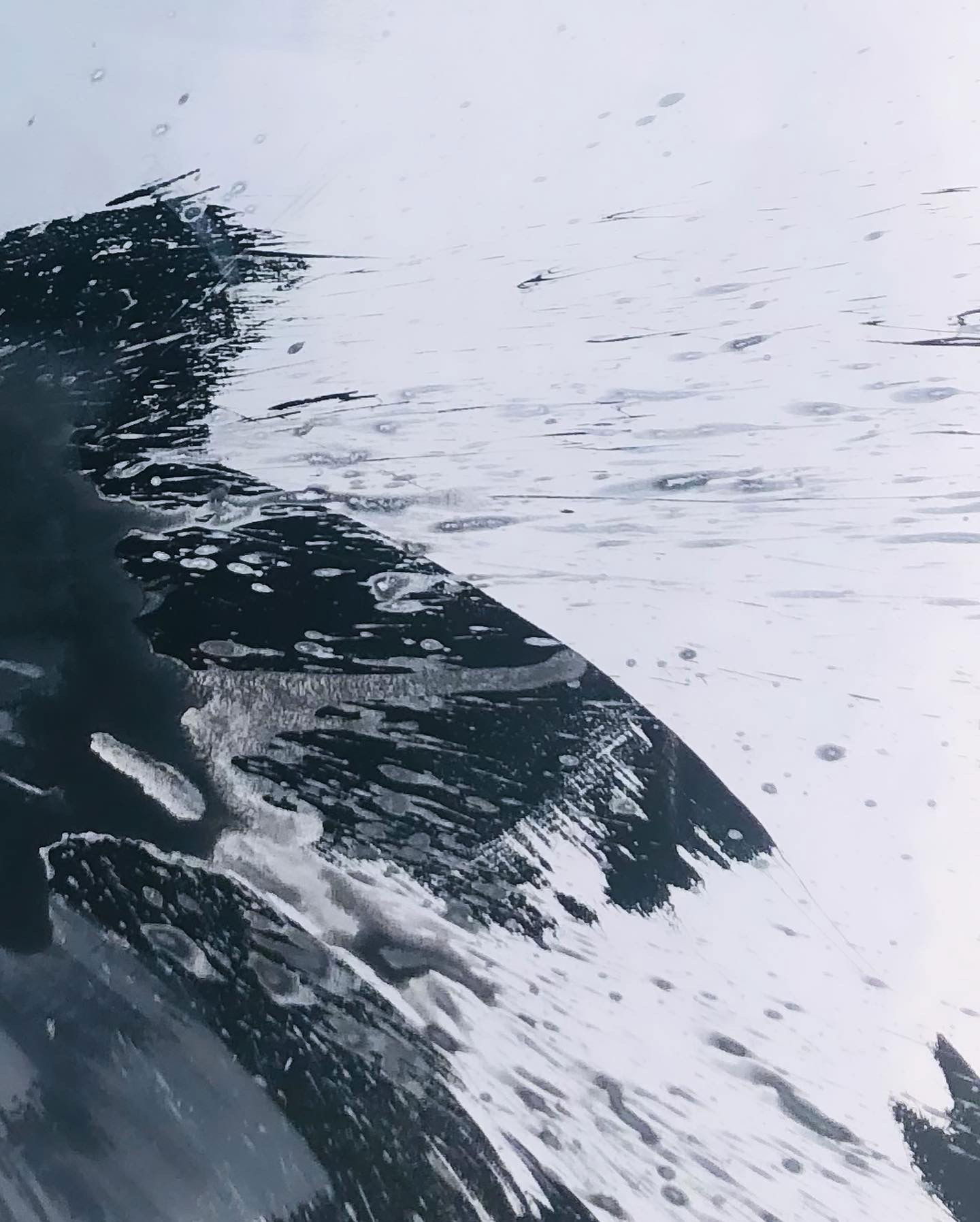 A monochrome abstract acrylic painting on canvas, portraying dynamic fluidity and turbulent motion with bold contrasts. Layers of grayscale create an organic, ethereal mystery. Artwork style - Abstrakt and technique Acryl auf Leinwand.